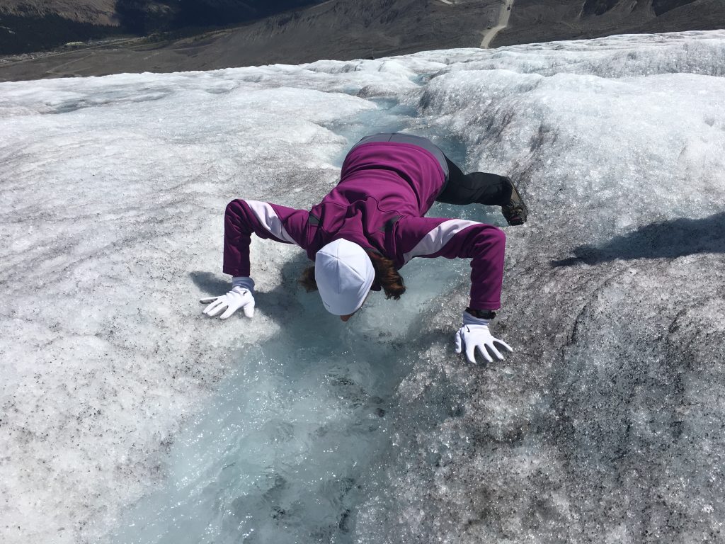 Taking a drink of glacier water after ice climbing on the Athabasca Glacier on the Columbia Icefields near Jasper National Park