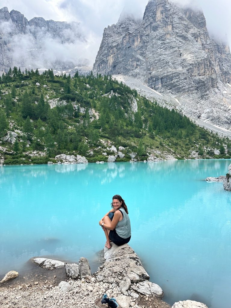 Hike to alpine lake with mountains in the Dolomites, Italian Alps