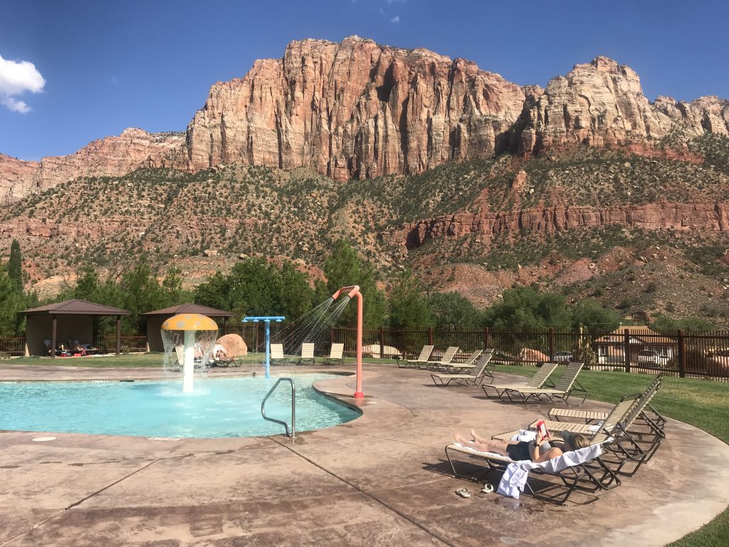 traveler relaxing at hotel outside of Zion National Park with red rock canyon views