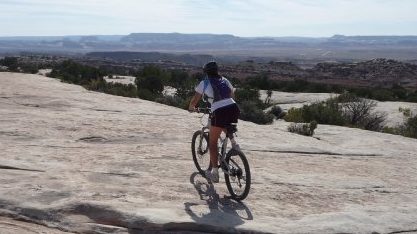 Mountain biking for a Moab adventurer trip on slickrock near Canyonlands National Park in Utah
