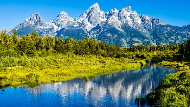 Stunning Grand Tetons mountains reflecting in Jenny Lake at Grand Teton National Park