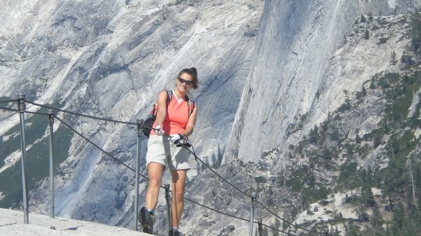 Adventure travel hike up the final portion of the Half Dome, a steep ascent of about 400 vertical feet up the bare granite face of the dome to reach the summit of Half Dome in Yosemite National Park, permit required