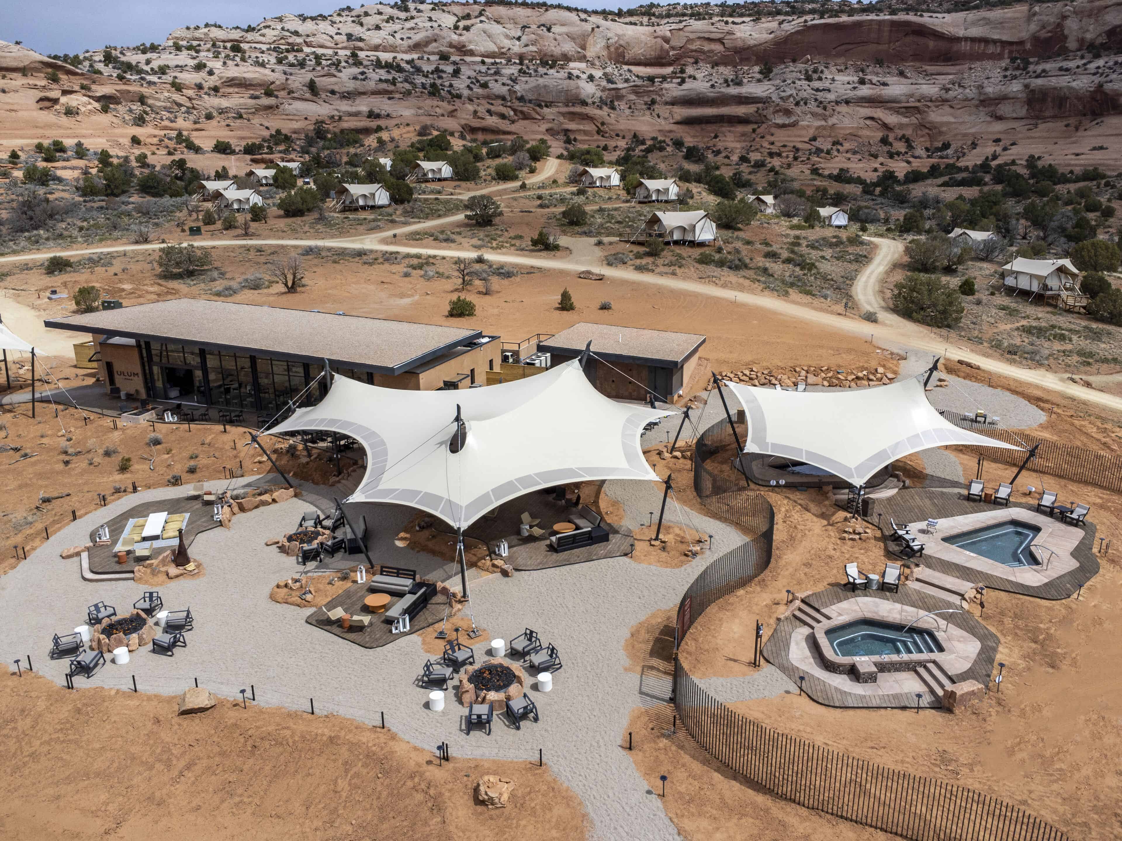 Aerial view ULUM Moab with luxury glamping tents, outdoor seating areas, and hot tubs, near Moab and Arches National Park