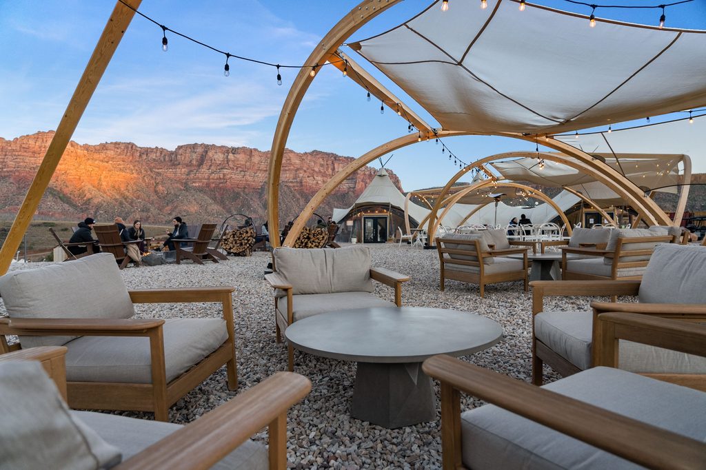 Glamping at Under Canvas Zion National Park with red rock cliffs in the background
