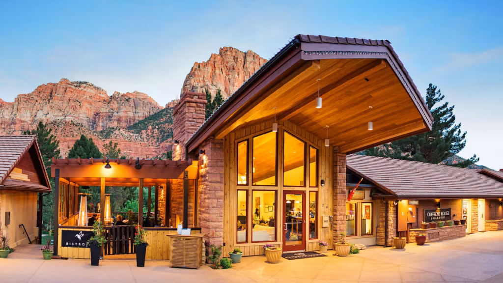 Exterior of Cliffrose Hotel, Zion Natinal Park with red rock mountains in the background