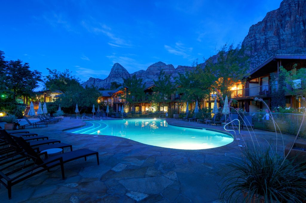 Desert Pearl Inn at Zion with pool and red rock mountain background
