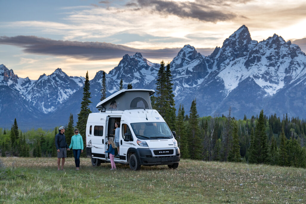 Family in Luxury RV by the snow covered mountains in Grand Teton National park