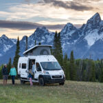 Family in Luxury RV by the snow covered mountains in Grand Teton National park
