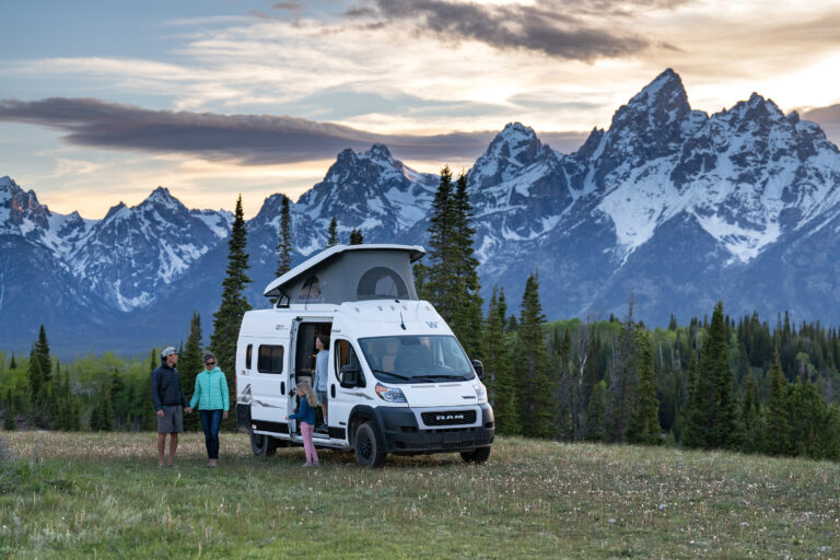 Family in Luxury RV by the snow covered mountains in Grand Teton National park