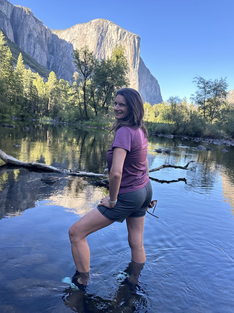 Playing and splashing in the Merced river at Yosemite National Park with El Capitan in the background