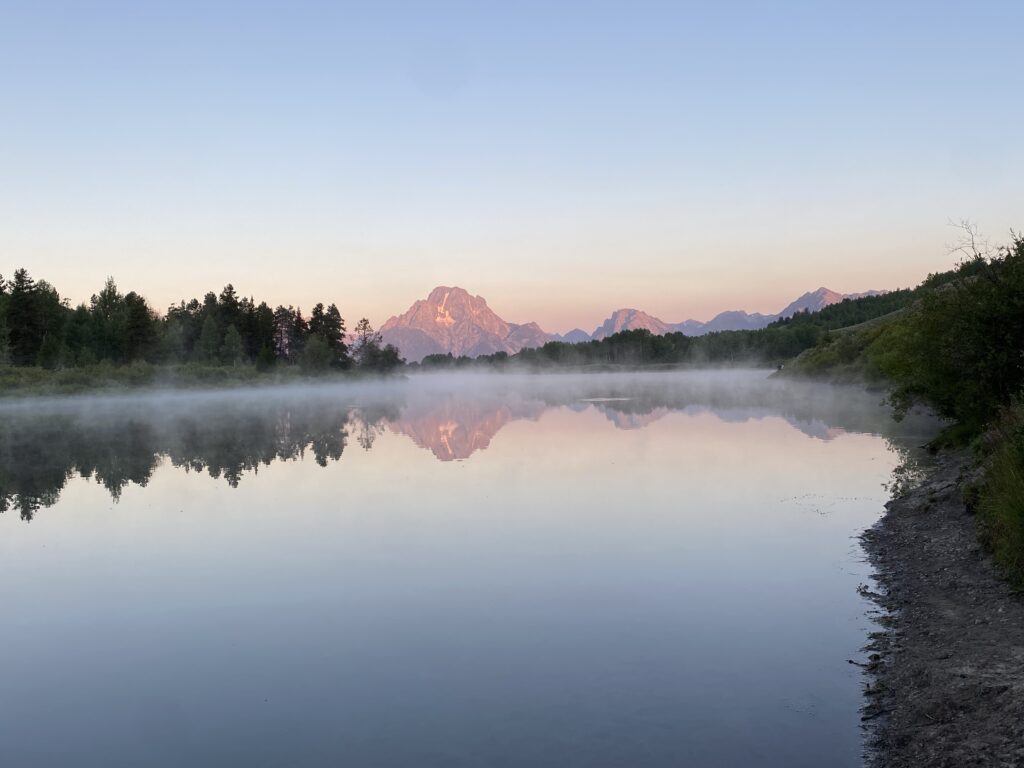Reflection of the Grand Tetons in water at Sunrise