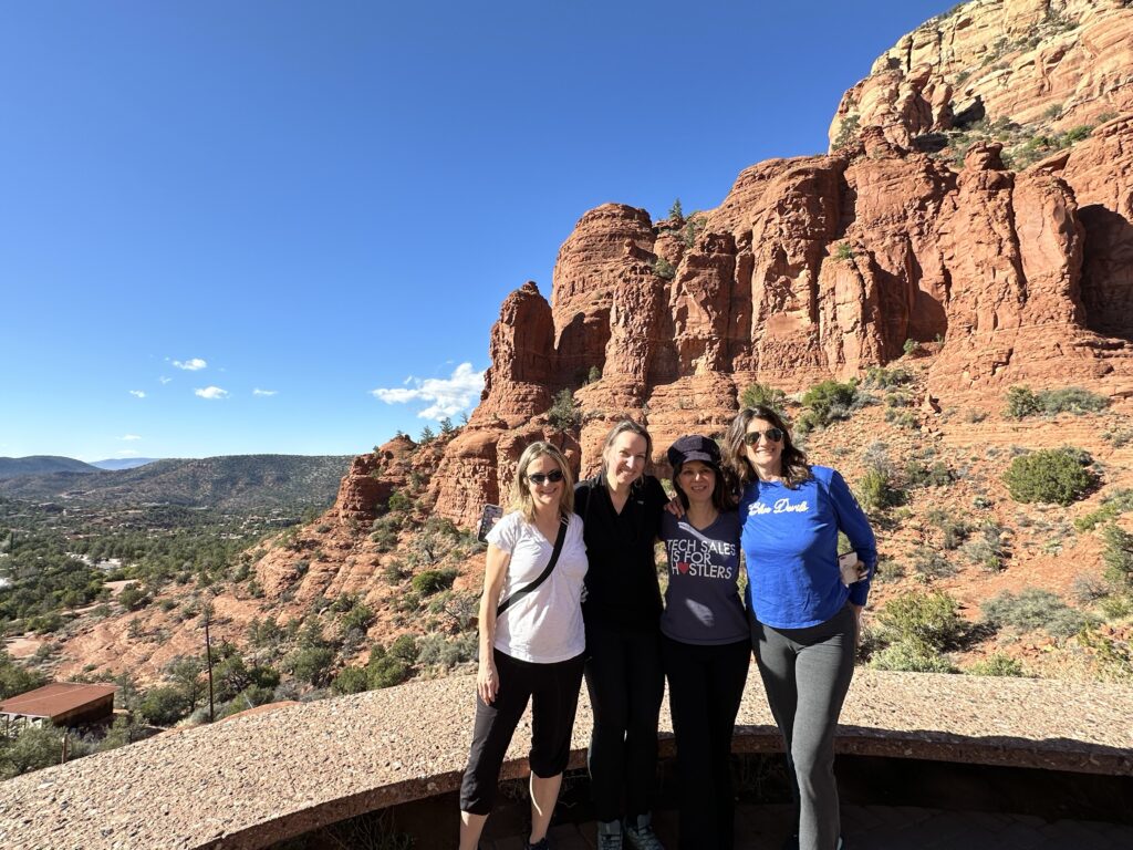 Group of 4 women in front of the red rocks in Sedona Arizona near Chapel of the Holy Cross